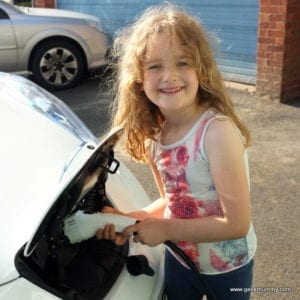 girl charging a Nissan LEAF car