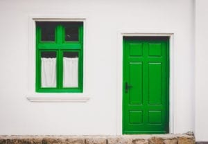 building with green doors by Buzac Marius