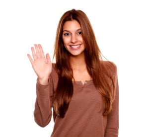 woman saying hello by Pablo Calvog via Shutterstock