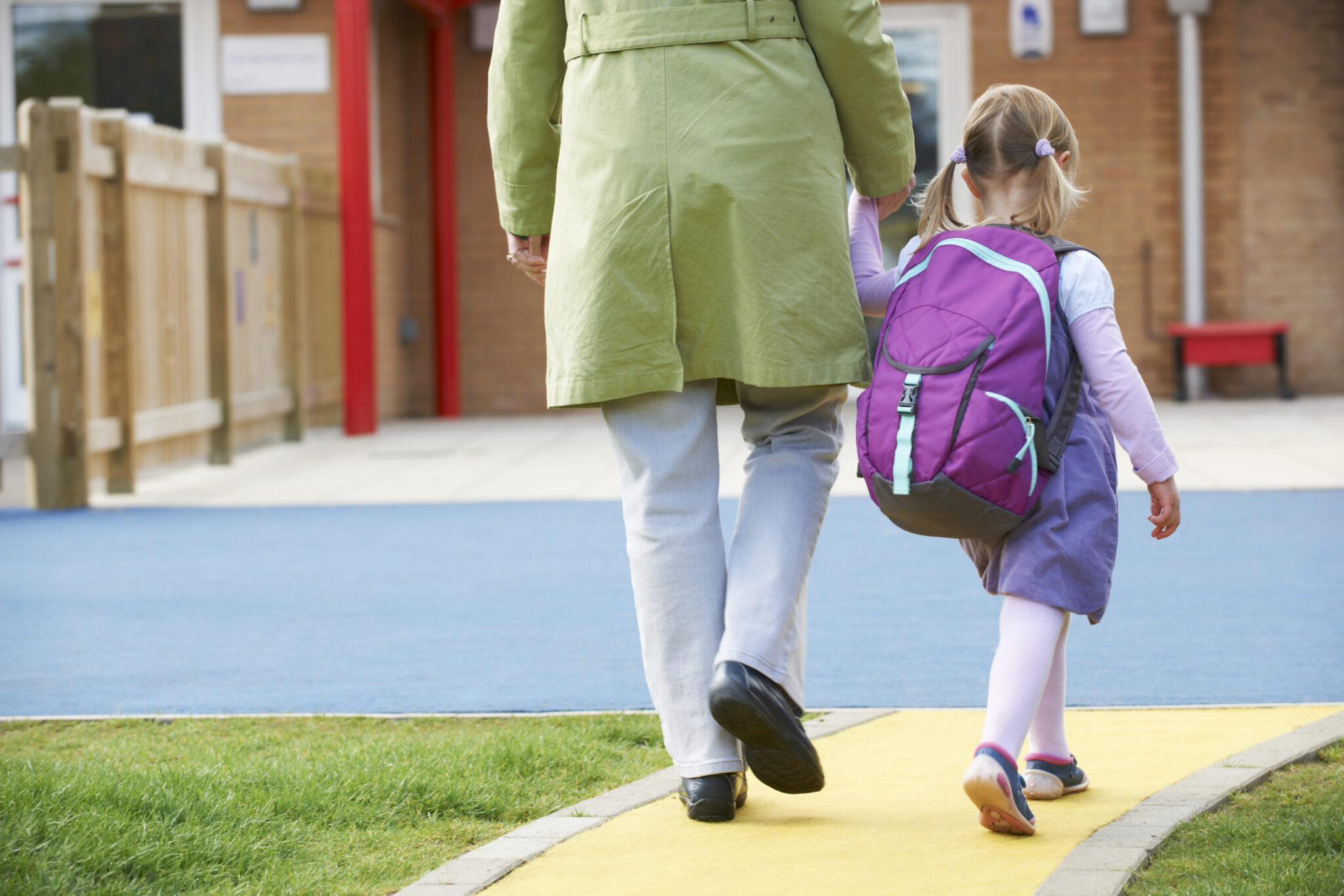 Shutterstock image of parent dropping child off at school