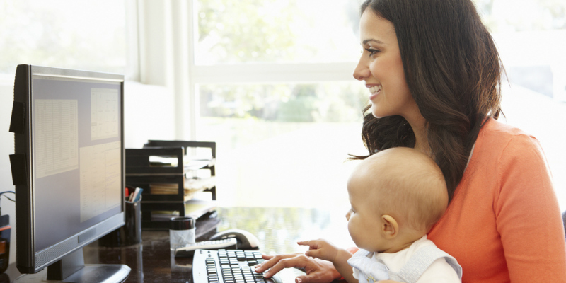 mum at computer with baby on BritMums