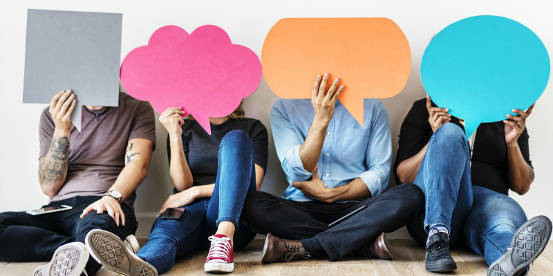 people holding up speech bubbles - BritMums