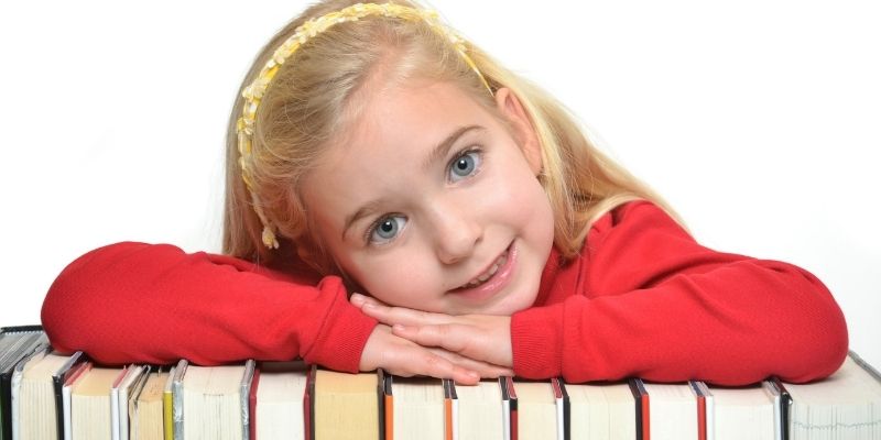 girl leaning on books