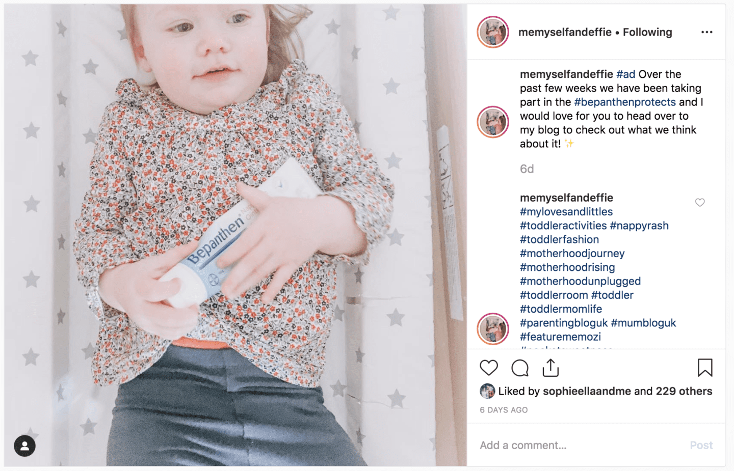 baby on changing mat holding Bepanthen cream - BritMums