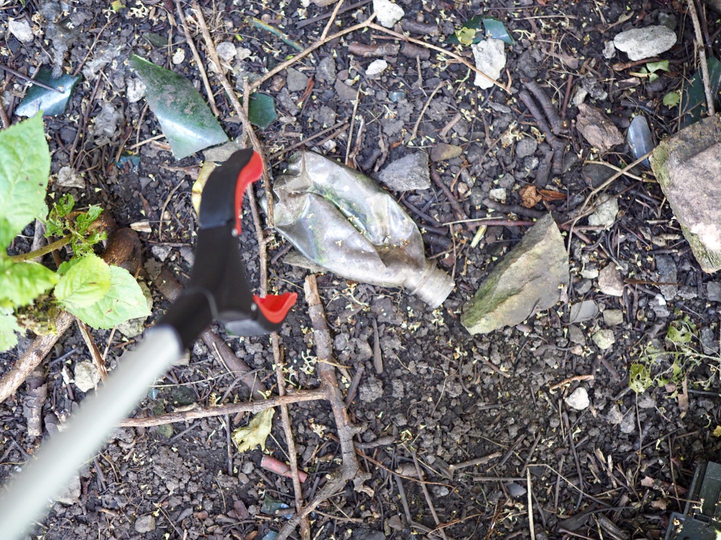picking up plastic bottle with grabber