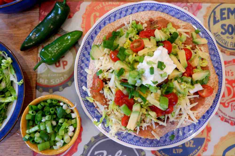 Mexican Minced Beef Tostada with peppers and spring onions on the side