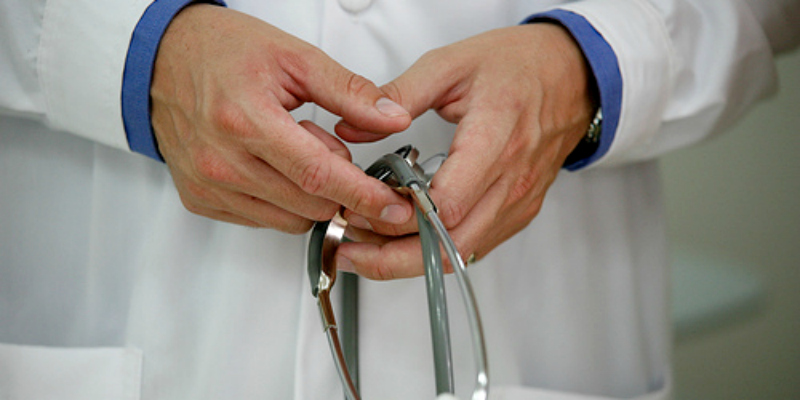 doctor's hands holding stethoscope