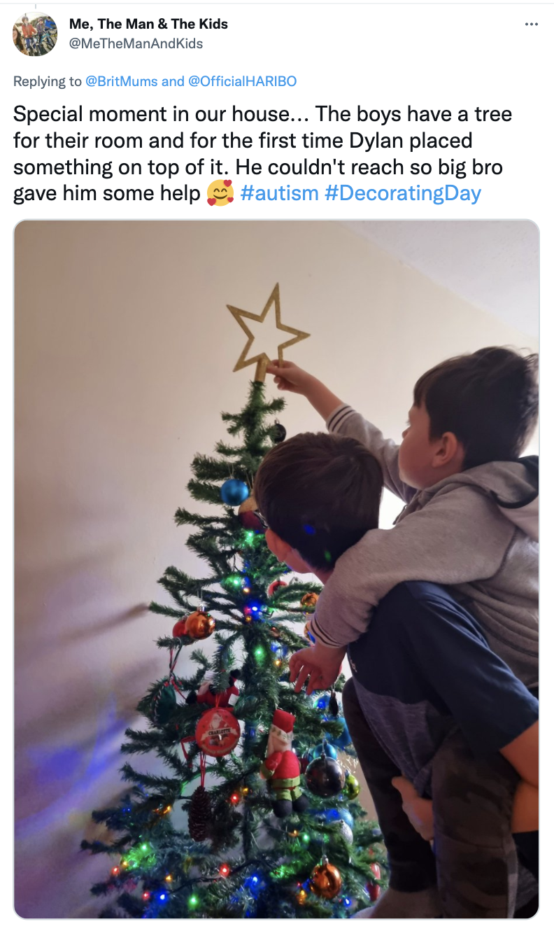 boys putting star ono top of the tree
