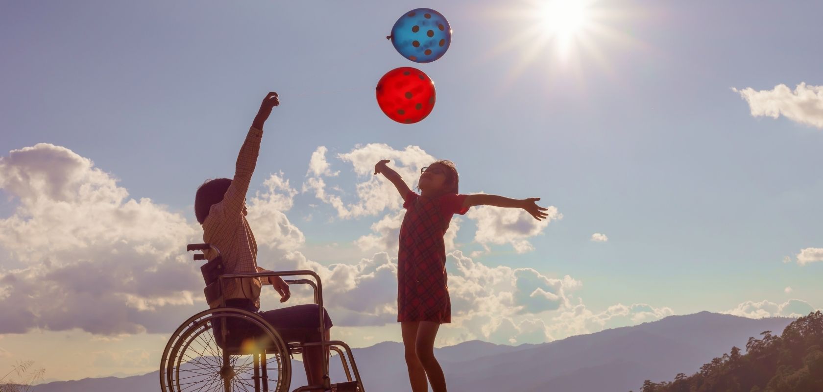 happy children one in wheelchair with balloons